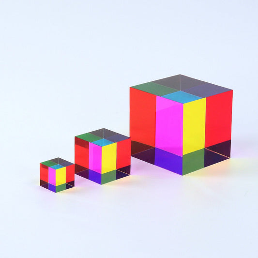A translucent CMY Cube held to the light, its faces overlapping into colours the eye rarely sees